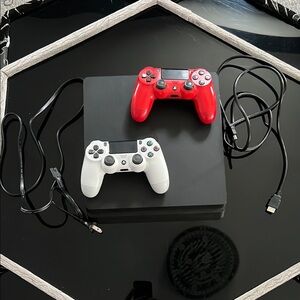 PlayStation 4 with a red and white controller and one HDMI cable and Power cord.